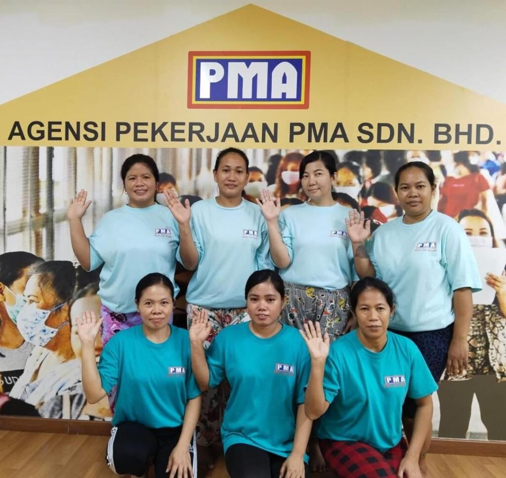 PMA agency staff assisting a domestic helper at the Penang office
